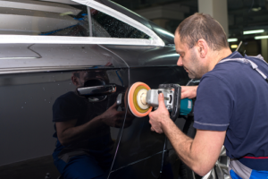 Technician Preparing car surface to apply car sticker