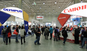 Crowd at a tradeshow surrounded by several booths and Tradeshow Display signs