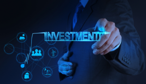 hand placed on digital investment sign