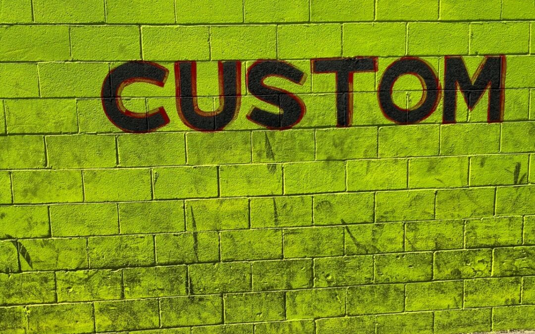 a lime green brick wall with the word "custom" painted on it