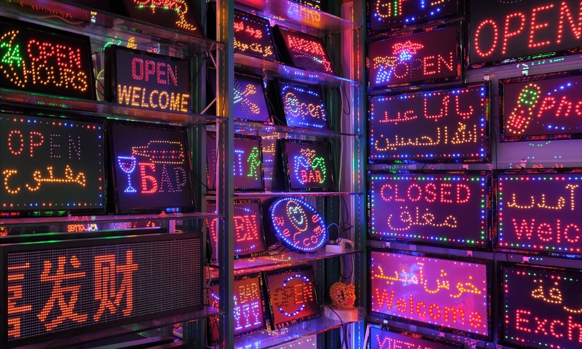 shelves filled with "open" and "closed" LED signs