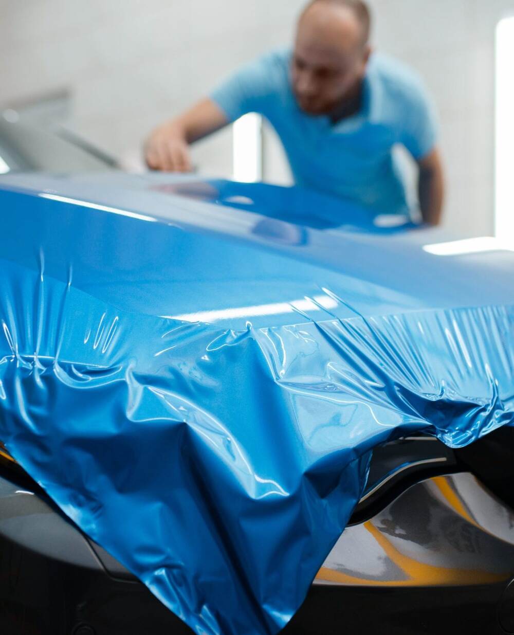 Car wrapping Expert installs protective vinyl foil Car wrapping Expert installs protective vinyl foil